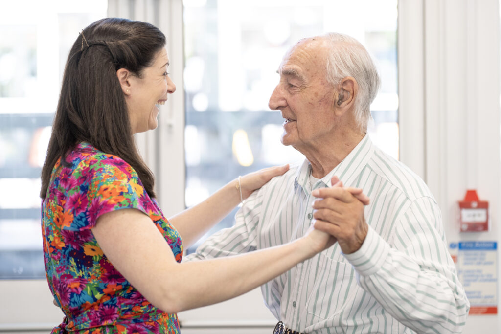 Suzi Saperia from Duetto Florens dancing with participant at Retford Library Songs & Scones, May 2025